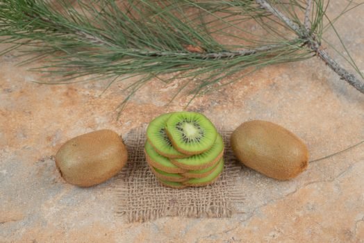 Kiwi and kiwi slices on marble surface Kiwi and kiwi slices on marble surface. High quality photo